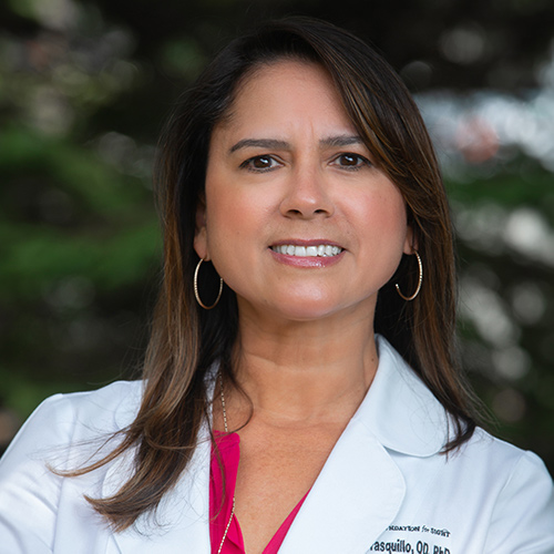 Dr. Karen G. Carrasquillo headshot with white coat